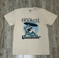 Cream Beige t-shirt with a graphic design of a woman under an umbrella and text 'Sorry I'm Booked for the Summer.' Perfect for the Book Lover.