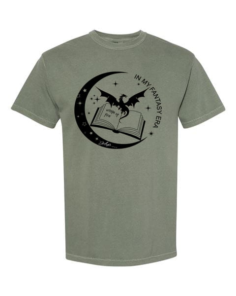 The Noctelle Tee captures the majesty of dragons and the magic of books in one beautifully detailed graphic. An intricate dragon illustration paired with a stack of books on a rich moss green tee — earthy, epic, and made for the reader who lives for high fantasy and romantasy worlds.