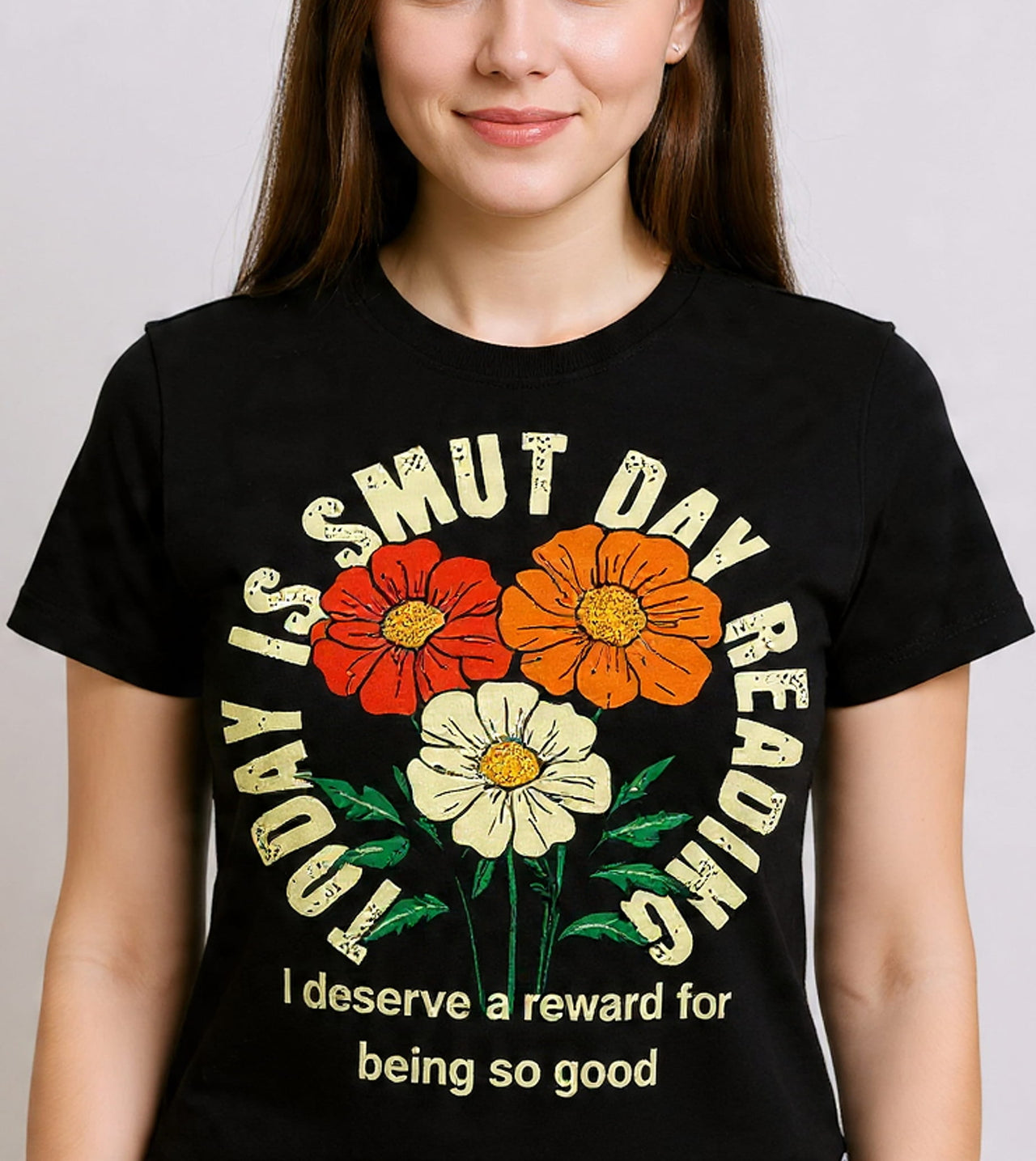 Person wearing a black t-shirt with colorful floral design and text.