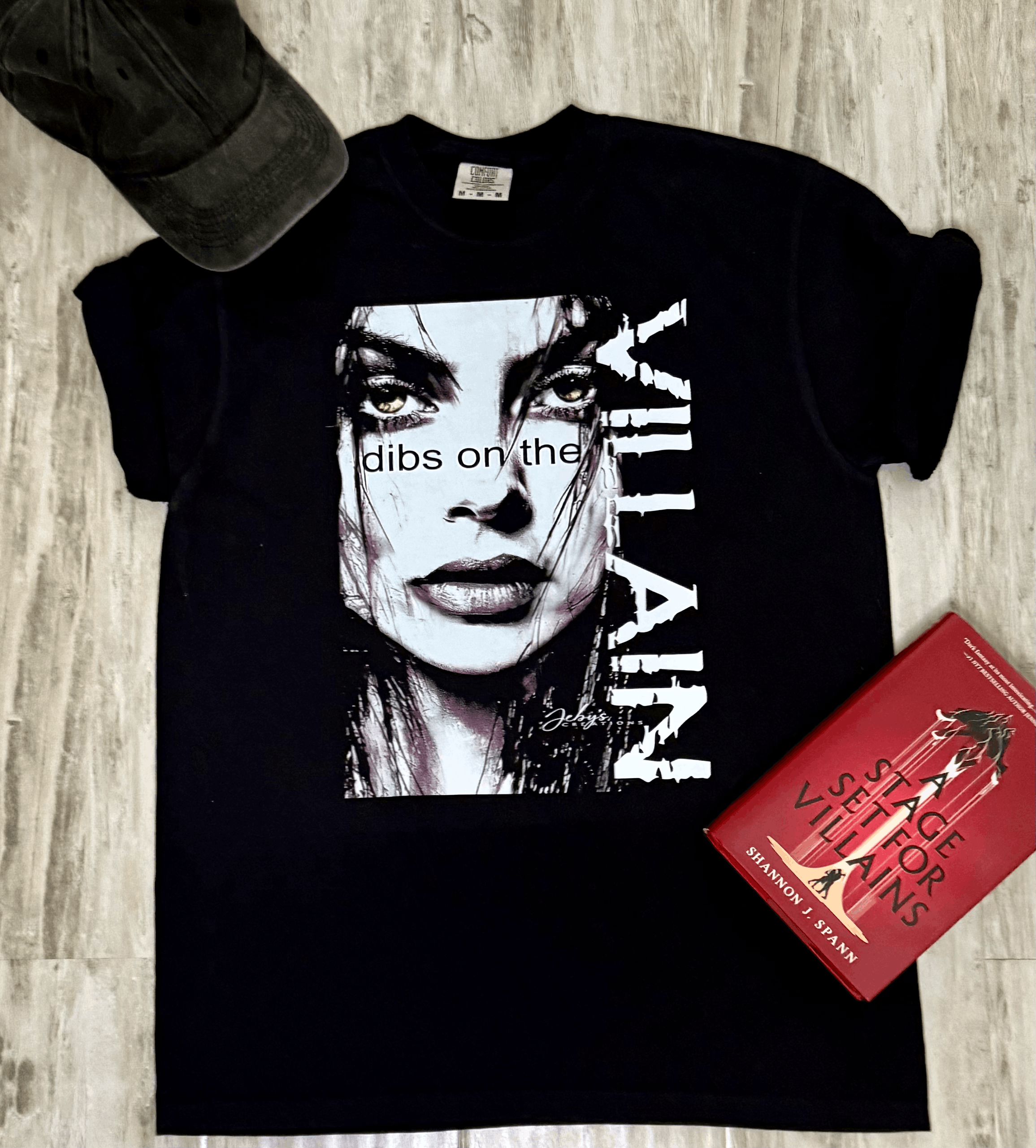 A woman wearing a black t-shirt with a graphic design and text Dips on the Villain.